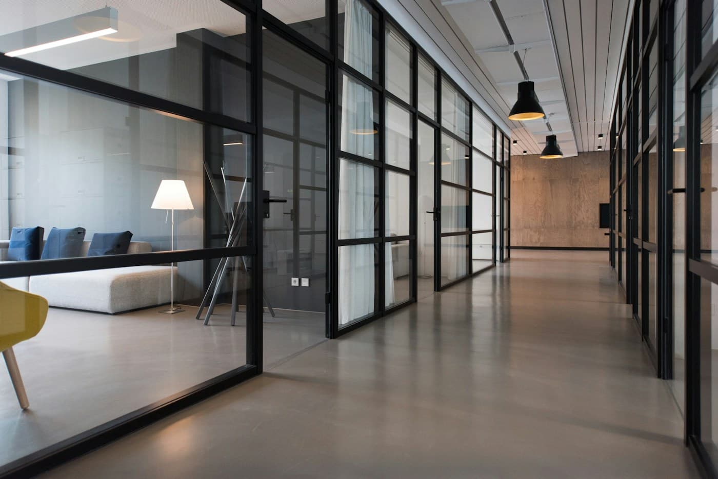 An open creative workspace with long shared tables and natural light